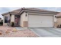 Single-story home featuring a well-maintained front yard and attached two-car garage at 6445 Glory Rise Ct, Las Vegas, NV 89142