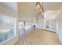 Spacious living room with hardwood floors, high ceilings, fireplace, and lots of natural light at 6944 Emerald Springs Ln, Las Vegas, NV 89113