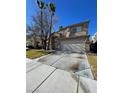 Inviting two-story home with desert landscaping and a two-car garage on a sunny day at 7213 Buglehorn St, Las Vegas, NV 89131