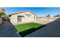 This home features a well maintained backyard with artifical turf and gravel at 7437 Lattimore Dr, Las Vegas, NV 89128