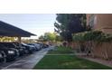 Community parking area with a view of the landscape, and a grass area at 8101 W Flamingo Rd # 1073, Las Vegas, NV 89147