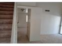 Hallway view featuring carpet, stairs to the left, and access to a living area at 8332 Shore Breeze Dr, Las Vegas, NV 89128