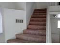Staircase with carpet steps and white wall with a floor vent at 8332 Shore Breeze Dr, Las Vegas, NV 89128