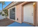 Home featuring stucco siding, a sliding glass door, and desert-style landscaping at 8425 Sewards Bluff Ave, Las Vegas, NV 89129