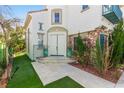 Home entrance featuring double doors, stone accents, and desert landscaping at 916 Granger Farm Way, Las Vegas, NV 89145
