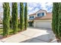 Attractive home boasts a two-car garage, lush landscaping, and a second story balcony at 916 Granger Farm Way, Las Vegas, NV 89145