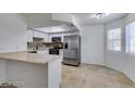 Modern kitchen with stainless steel appliances and a breakfast bar at 924 Falconhead Ln # 102, Las Vegas, NV 89128