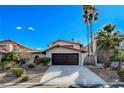 Exterior home view features a charming desert landscape, driveway, and mature palm trees at 945 Vegas Valley Dr, Las Vegas, NV 89109