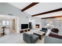Spacious living room features wood beams, stone fireplace, tiled floors, and stylish decor at 945 Vegas Valley Dr, Las Vegas, NV 89109