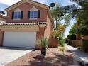 Charming two-story home with a convenient two-car garage and mature landscaping at 9937 La Paca Ave, Las Vegas, NV 89117