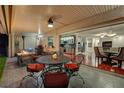 Charming covered patio with comfortable seating, dining area, and access to a well-appointed indoor space at 10621 Tinta Ln, Las Vegas, NV 89144