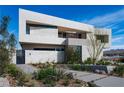 Modern home exterior with clean lines, desert landscaping, and a private courtyard at 1572 Pleasant Bay Ct, Henderson, NV 89011