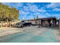 Attached covered carport and expansive driveway with ample parking on a sunny day at 1808 Walnut Ave, Las Vegas, NV 89101