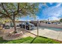 Spacious driveway with mature tree in the front yard of this cozy single-story home at 1808 Walnut Ave, Las Vegas, NV 89101