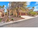 Attractive two-story house featuring a tile roof,desert landscaping and a two-car garage at 1912 Sierra Oaks Ln, Las Vegas, NV 89134