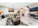 Cozy living room with a comfortable gray couch, stylish rug, and decorative beams at 1920 Parkchester Dr, Las Vegas, NV 89108