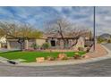 Attractive home featuring desert landscaping, mature trees, and a well-maintained lawn in a suburban setting at 2602 Evening Sky Dr, Henderson, NV 89052