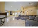Bright living room with marble floors, a comfortable sectional sofa, and ample natural light at 2608 Port Of Call Dr, Las Vegas, NV 89128