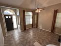 Bright living room features tile flooring, vaulted ceiling, and natural light from multiple windows at 3047 Whispering Crest Dr, Henderson, NV 89052
