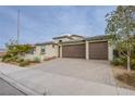 Charming single-story home featuring a three-car garage and desert landscaping at 324 S Lisbon St, Henderson, NV 89015