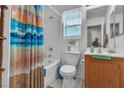 Cozy bathroom featuring a shower-tub combo, single sink vanity, and a window for natural light at 3335 Wasatch Cedars St, Las Vegas, NV 89122
