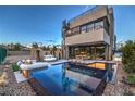 Backyard oasis features a modern pool, lounge seating, and an outdoor dining area for relaxation and entertainment at 4077 Heron Fairway Dr, Las Vegas, NV 89141