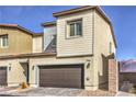 Two-story home showcasing a two-car garage door and manicured landscaping at 4234 Lunar Canyon Ave, North Las Vegas, NV 89084