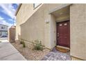 Home featuring a red front door with a brick paved walkway and gravel landscaping at 4234 Lunar Canyon Ave, North Las Vegas, NV 89084