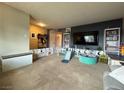 Spacious carpeted living area with dark accent wall at 4262 Tarkin Ave, Las Vegas, NV 89120