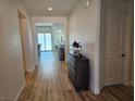 Elegant entryway with wood-look flooring, neutral paint and a stylish wood cabinet at 5051 Fairmont St, Pahrump, NV 89061