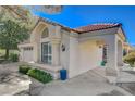 Beautiful exterior of the home with a covered entryway, red tile roof, and well-maintained landscaping at 5429 Painted Sunrise Dr, Las Vegas, NV 89149