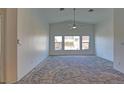 Living room showcasing vaulted ceilings, carpet and natural light from three windows at 5457 Jackpot Winner Ln # 101, Las Vegas, NV 89122