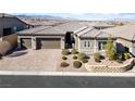Charming single-Gathering home with a three-car garage, manicured landscaping, and an inviting curb appeal at 6192 Lautman Ridge Ct, Las Vegas, NV 89141