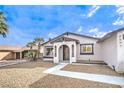 Inviting single-story home with desert landscaping, a walkway, and a covered front porch at 6597 Mountainwood Ln, Las Vegas, NV 89103