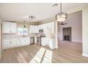 Bright kitchen with white cabinets, stainless steel appliances, and modern lighting fixtures at 6597 Mountainwood Ln, Las Vegas, NV 89103