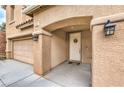 Inviting front entrance with a decorative wreath and stylish exterior lighting at 6736 Sugarbird Ct, North Las Vegas, NV 89084