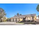 Beautiful single-story house showing a 3-car garage and mature desert landscaping at 6741 Philippe Allen Ave, Las Vegas, NV 89110