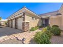Single-story home featuring a 3-car garage, stone accents, and desert landscaping at 6741 Philippe Allen Ave, Las Vegas, NV 89110