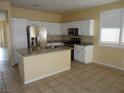 Bright kitchen features white cabinets, stainless steel appliances, and granite countertops at 7929 Palace Monaco Ave, Las Vegas, NV 89117
