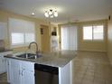 This is a spacious kitchen and dining room combo with tile flooring and lots of natural light at 7929 Palace Monaco Ave, Las Vegas, NV 89117