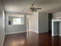 Open-concept living room with dark hardwood floors and abundant natural light at 8212 Calico Wind St, Las Vegas, NV 89131
