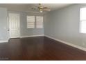 Bright and airy living room featuring hardwood floors and large windows at 8212 Calico Wind St, Las Vegas, NV 89131