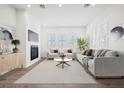 Bright living room with fireplace, modern furnishings and lots of natural light at 9032 Skye Canyon Ranch St, Las Vegas, NV 89166
