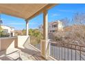 Enjoy the neighborhood view from this home's private balcony with wrought iron railings at 9823 Lime Tree St, Las Vegas, NV 89178