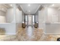 Elegant foyer featuring tile flooring, decorative columns, and a grand entrance door with sidelights at 10129 Elk Valley St, Las Vegas, NV 89178