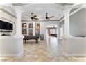 Spacious living room featuring tile floors, ceiling fans, and an open floor plan at 10129 Elk Valley St, Las Vegas, NV 89178