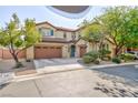 Charming two story home with a three car garage, desert landscaping and muted green shutters at 10288 Grizzly Forest Dr, Las Vegas, NV 89178