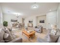 Spacious living room with hardwood floors and a dining area for entertaining at 11069 Crystal Crest Ct, Las Vegas, NV 89135