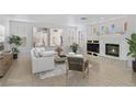 Cozy living room showcasing a fireplace, white sofa, and neutral decor at 1401 Via Savona Dr, Henderson, NV 89052