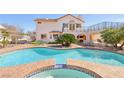 Stunning backyard oasis with a large pool, spa, patio, and lush landscaping at 1634 Georgia Ave, Boulder City, NV 89005
